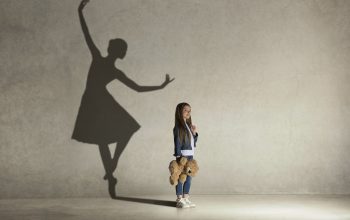 Baby girl dreaming a dancing ballet on the stage. Childhood concept.